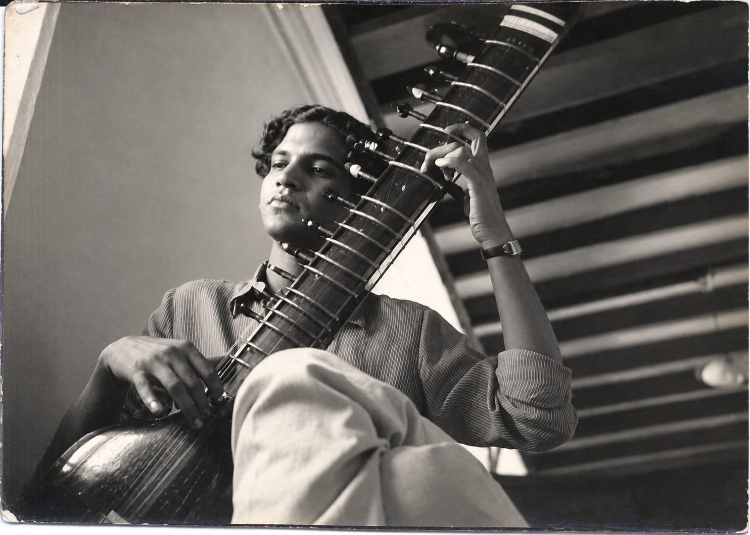 The young artist playing his sitar, restored
