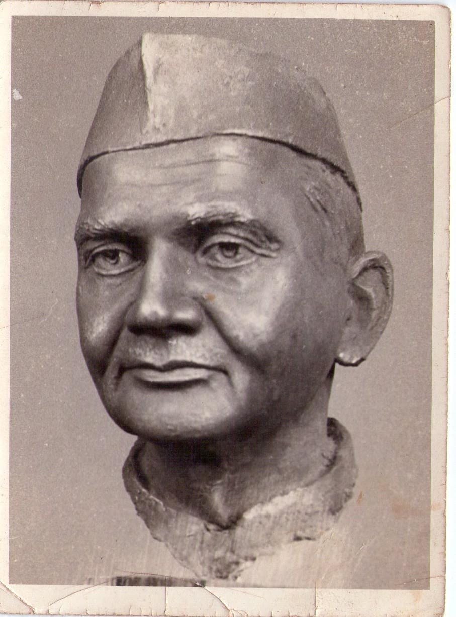 Bronze bust of a man with Gandhi cap
